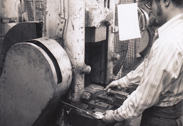 An Irwin employee at work using a coining machine, 1972